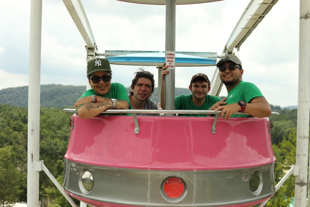 Summit travelers ride together at an amusement park.